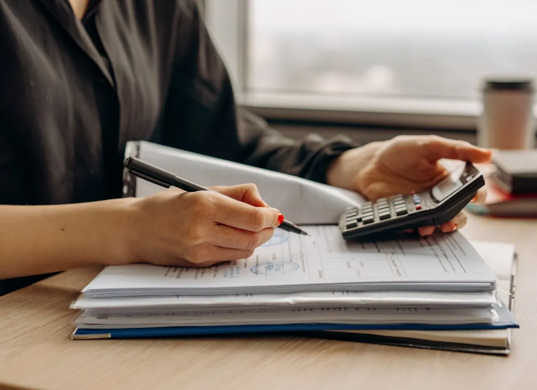 Contractors reviewing financial documents and project costs together