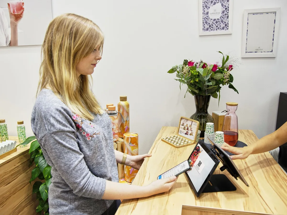 Store owner checking sales